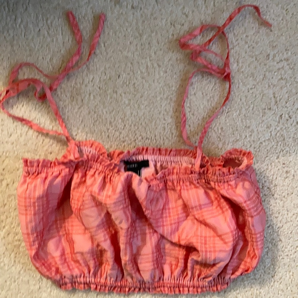 Pink plaid tank top with tied spaghetti straps at the top